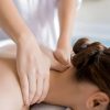 Registered massage therapist providing targeted neck and shoulder treatment